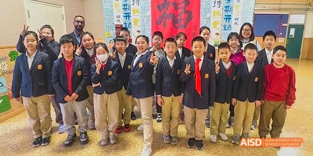 A photo showing a group of students in a playground, at Beijing Royal School.