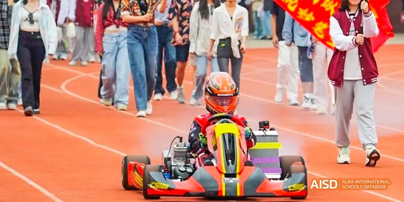 A photo showing a student driving a go-kart on a track, at Beijing Royal School.