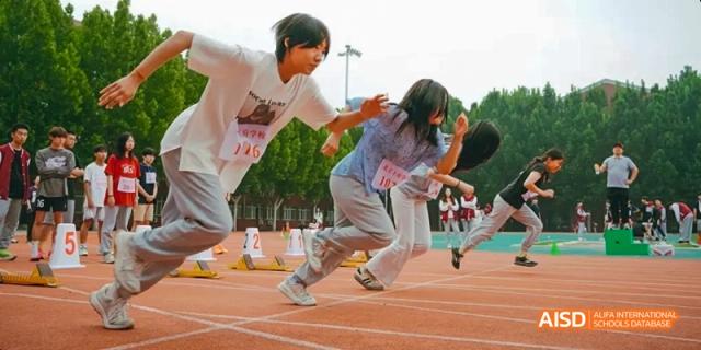 A photo showing a group of students participating in a running competition, at Beijing Royal School.