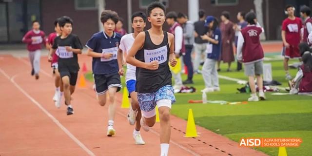 A photo showing students participating in a running competition, at Beijing Royal School.