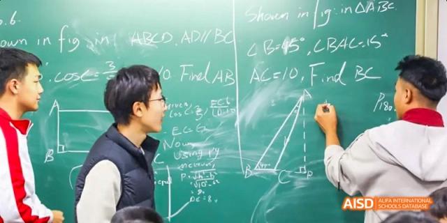Camford Royal School teacher explaining math problem on chalkboard