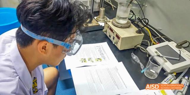 Camford Royal School student conducting experiment with lab equipment