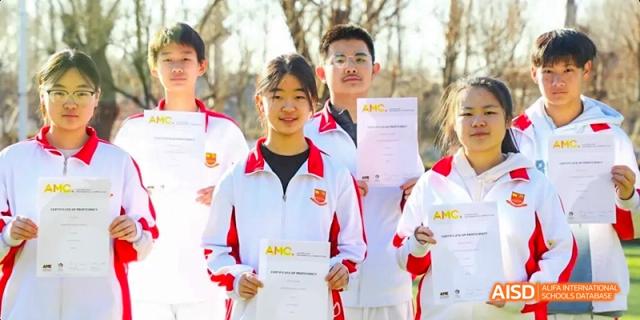Camford Royal School students posing outdoors with certificates, wearing school uniforms.