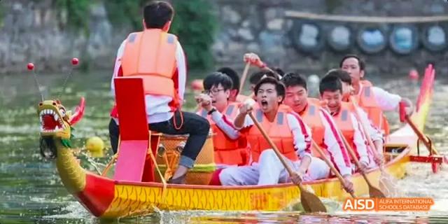 Camford Royal School students rowing a dragon boat during a water sport event