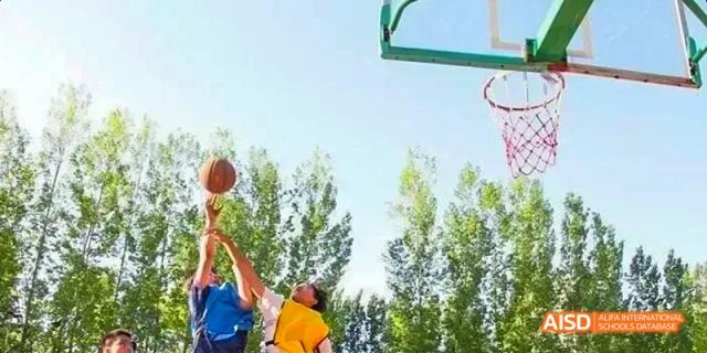 Camford Royal School students playing basketball on an outdoor court
