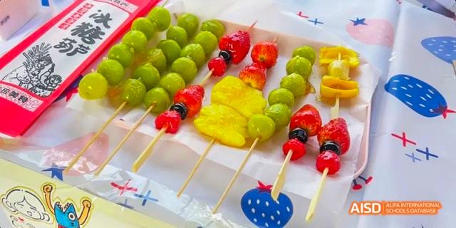 Camford Royal School fruit skewers with grapes, pineapple, and jelly treats arranged on a tray.