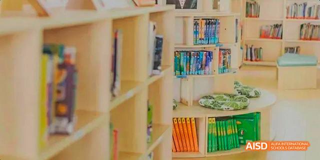 A shelf filled with various books is shown inside the library at the Canadian International School of Guangzhou.