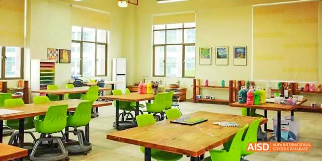 An empty classroom at the Canadian International School of Guangzhou is ready for a lesson, with desks and chairs neatly arranged.