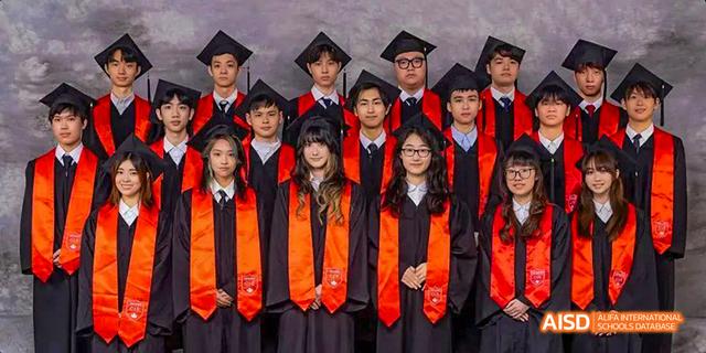 Three graduates from the Canadian International School of Guangzhou pose in their caps and gowns.