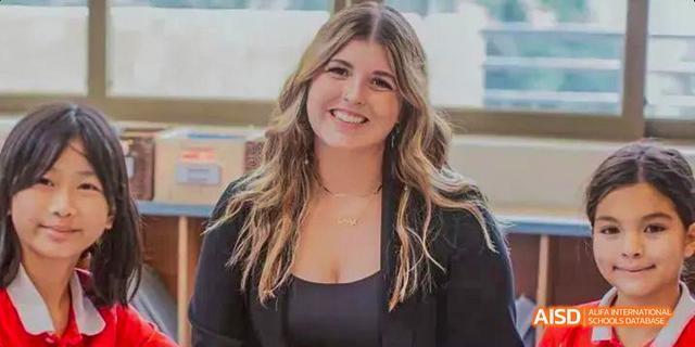 A portrait of a female student or staff member from the Canadian International School of Guangzhou smiling for the camera.