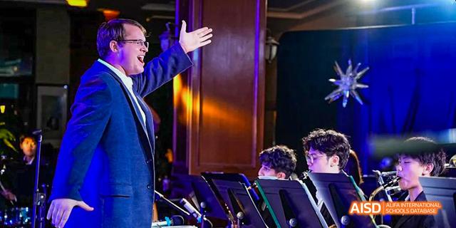 A close-up of a student in a concert setting, looking up at a conductor's hand, at the Canadian International School of Guangzhou.