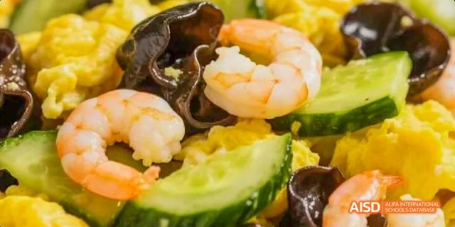 A close-up of a salad with shrimp, cucumber, and black fungus at Dalian American International School.