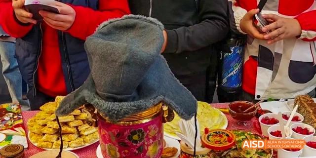 A close-up of a young person's hand holding a jar at Dalian American International School.