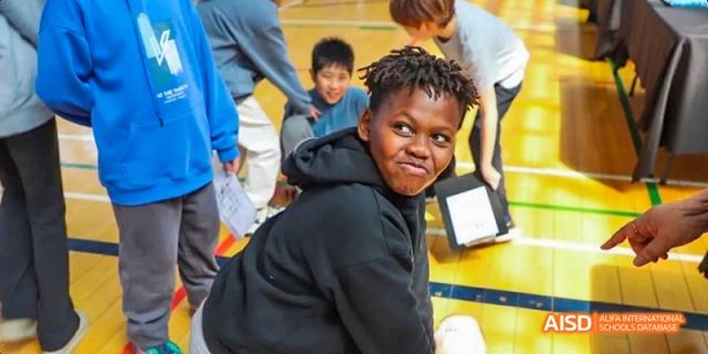 A young person at Dalian American International School smiling and looking at the camera.