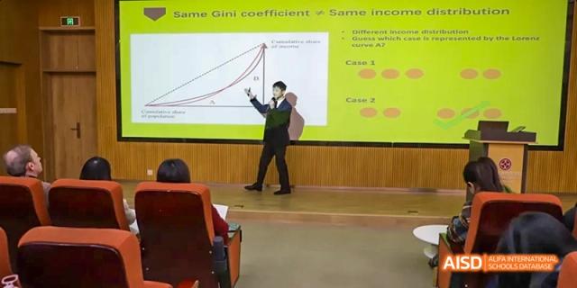 A teacher giving a presentation to students at Dipont KCS Chengdu.