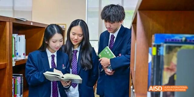 Two students in uniform reading books at Dipont KCS Chengdu.
