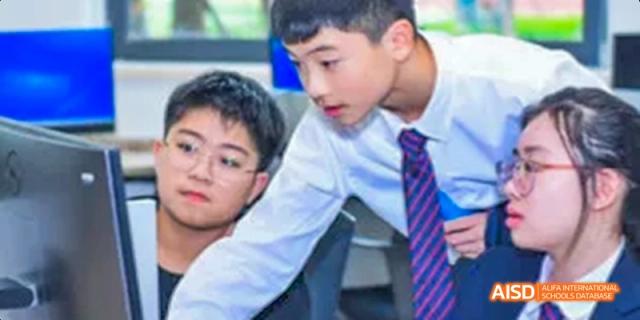 Two students looking at a computer screen in a classroom at Dipont KCS Chengdu.