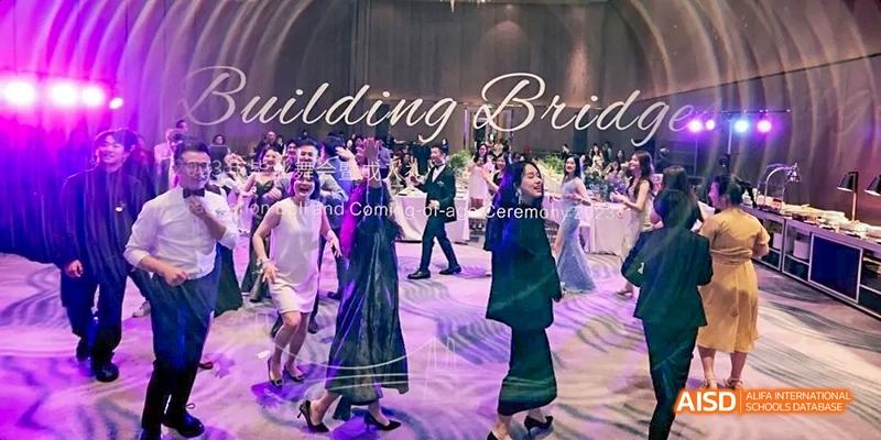 Students dancing at a ceremony or event at Dipont KCS Chengdu.