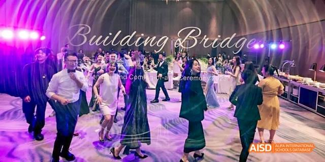 Students dancing at a ceremony or event at Dipont KCS Chengdu.