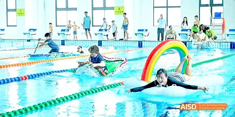 Dipont KCS Chengdu students compete in a swimming race in an indoor pool.