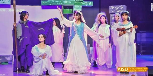 Dipont KCS Chengdu students in a variety of costumes perform on a stage.