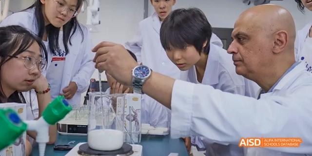 Ealing International School students in lab coats are conducting a science experiment.