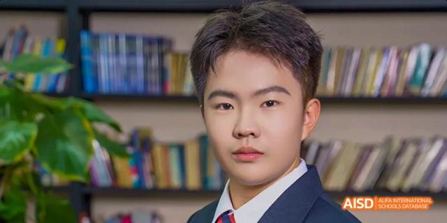 A close-up portrait of a male Ealing International School student.