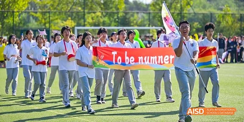 Ealing International School students holding a banner that says "To be numbered among".