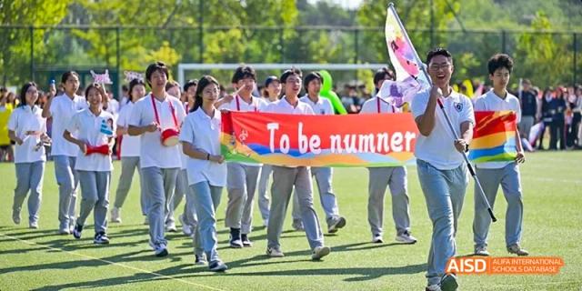 Ealing International School students holding a banner that says "To be numbered among".