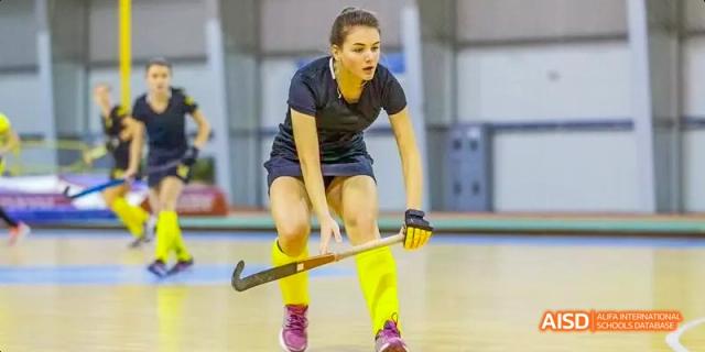 An Ealing International School student playing field hockey.
