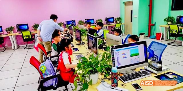 Students in red shirts working on computers in a computer lab at Fuzhou Concord College of Sino-Canada.
