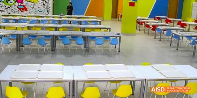 An empty cafeteria with blue and yellow chairs at Fuzhou Concord College of Sino-Canada.