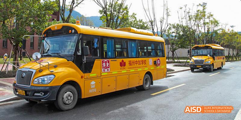 A school bus with the school name written in Chinese on its side at Fuzhou Concord College of Sino-Canada.