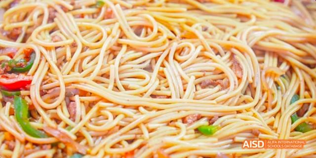Fuzhou Concord College of Sino-Canada students eating a bowl of noodles