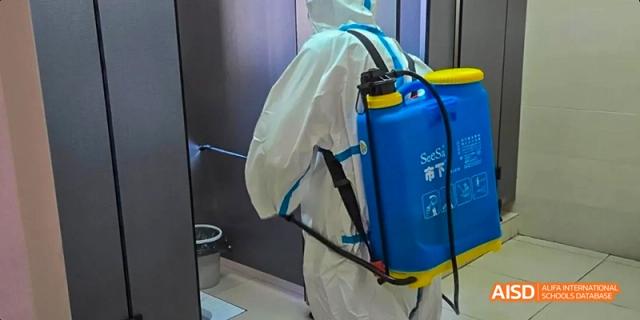 Fuzhou Concord College of Sino-Canada person in a hazmat suit with a backpack sprayer
