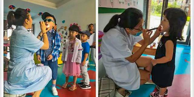 Fuzhou Concord College of Sino-Canada - Two young students, a girl in a pink dress and a boy, are standing with a teacher in a bright classroom.