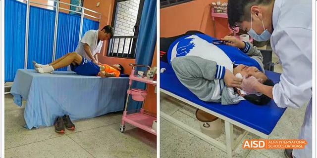 Fuzhou Concord College of Sino-Canada - A person in a white uniform is leaning over to examine a person lying on a hospital bed.