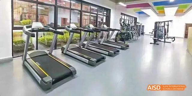 Fuzhou Concord College of Sino-Canada - An indoor gym with a row of treadmills and other fitness equipment.