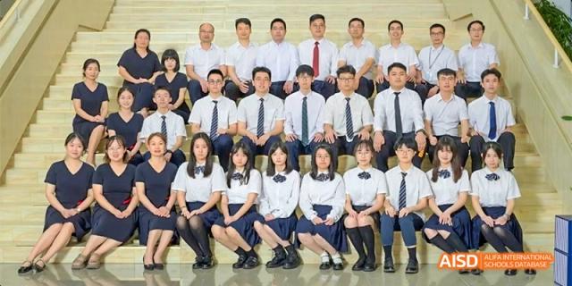 A large group of students and teachers from HAIDE Bilingual School Dongguan posing for a formal group photo.