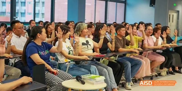 An audience of parents and students from HAIDE Bilingual School Dongguan seated in chairs, watching a presentation in a classroom.