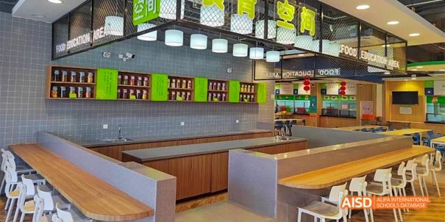 A modern, clean cafeteria kitchen and serving area at HAIDE Bilingual School Dongguan.