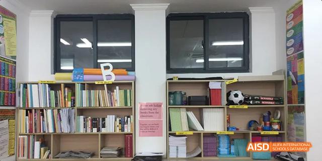 Interior view of a classroom or library section at Hangzhou Foreign Languages School, showing bookshelves filled with books and learning materials.