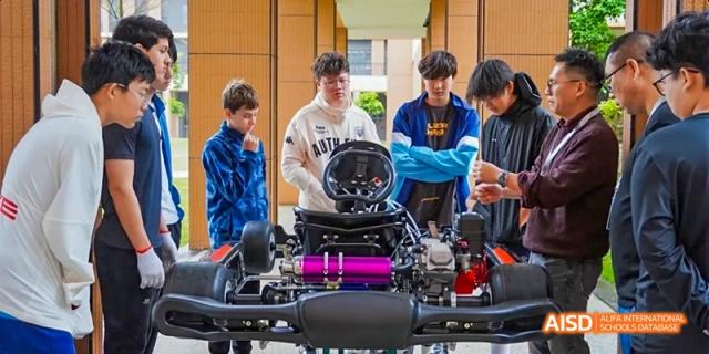 Students from Harrow LiDe School Haikou are working on a hands-on project with machinery.