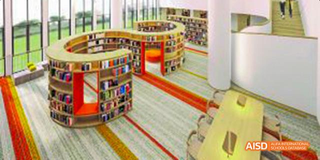 An aerial view of a library at Harrow LiDe School Haikou, showing bookshelves and a patterned carpet.
