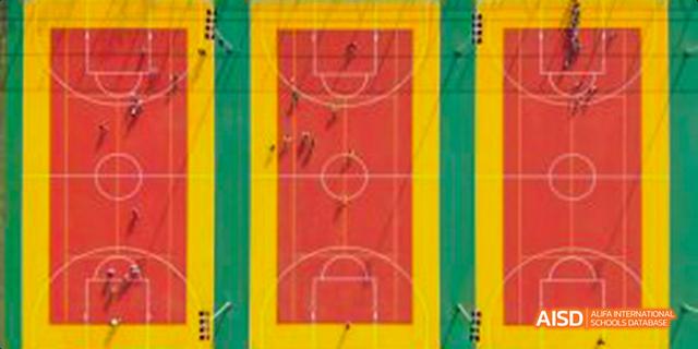 Aerial view of an outdoor sports court with students playing at Harrow LiDe School Haikou.