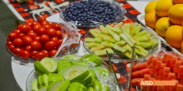 A close-up shot of sliced melon and other fruits displayed at an event at Harrow LiDe School Haikou.