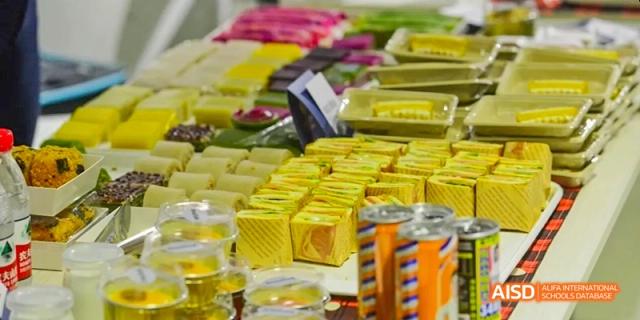 A stand with packaged snacks and drinks for sale at an event at Harrow LiDe School Haikou.
