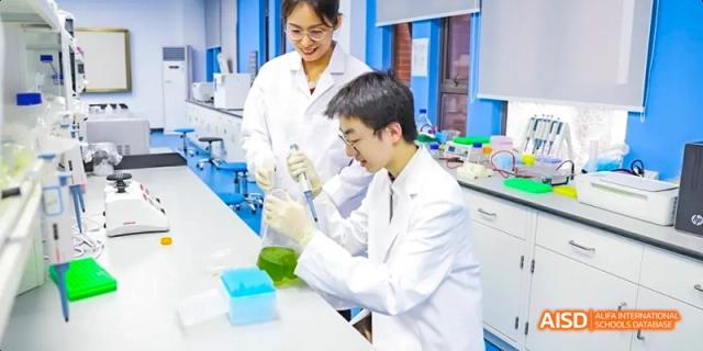 Hefei Thomas School students in a science lab, examining liquids in beakers.