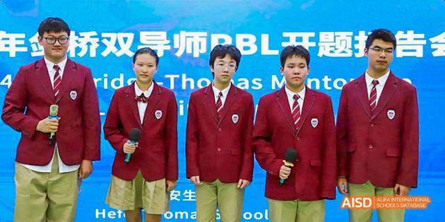 Hefei Thomas School students in matching red blazers posing for a photo.