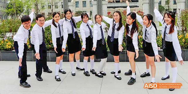 A group of female students from the International Department of Chengdu Shude High School posing outdoors in their uniforms.